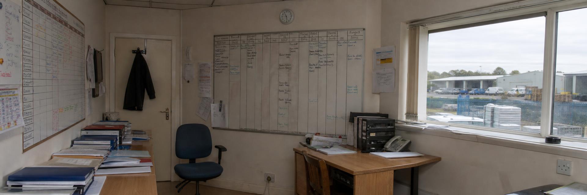 A planning board in a busy commercial office, used to track work through the week